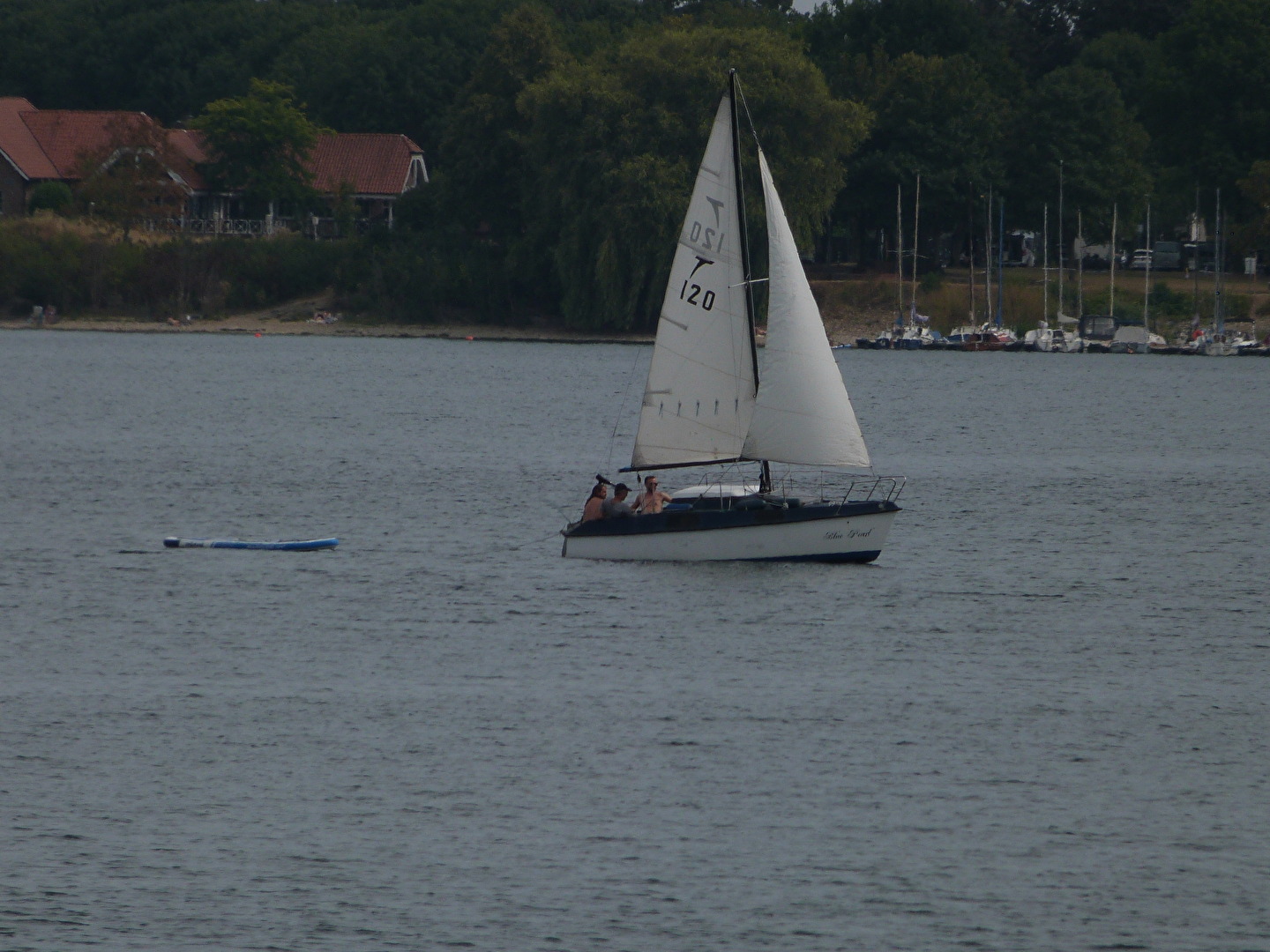 Three men on a sailboat