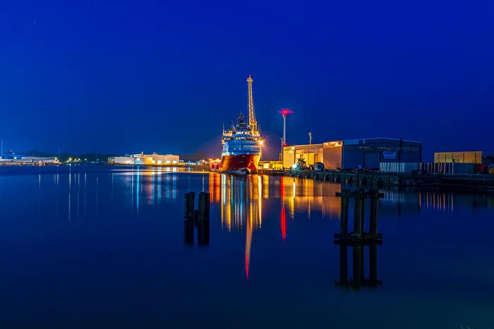 Still water in the harbor at the blue hour